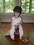 Cameron riding her pony with her little giraffe "thumby." 