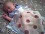 Sleeping cozy under a Little Giraffe blanky!