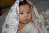 Here's adorable Elsie, wrapped in her cozy Luxe Dot blanket!