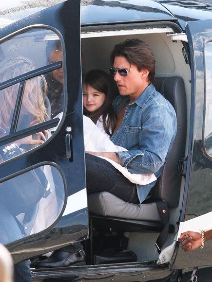 Suri on a Helicopter with a Little Giraffe Blanket